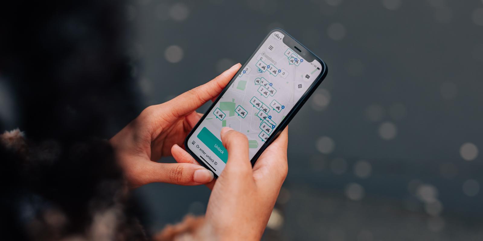 Woman using Beryl bike share app on mobile phone