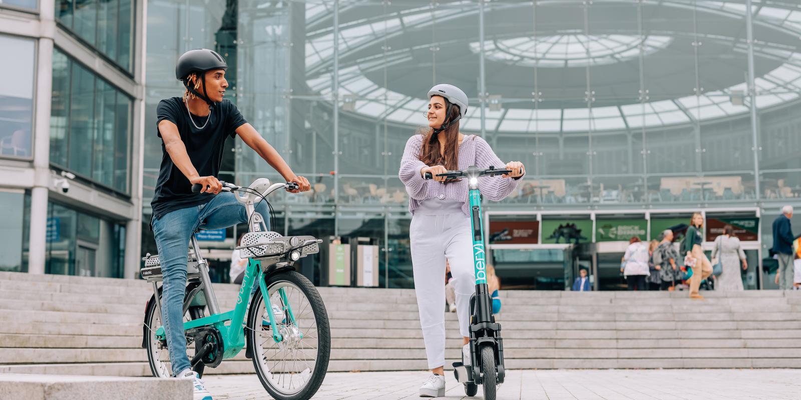 Man and woman riding Beryl e-bike and e-scooter in Norwich