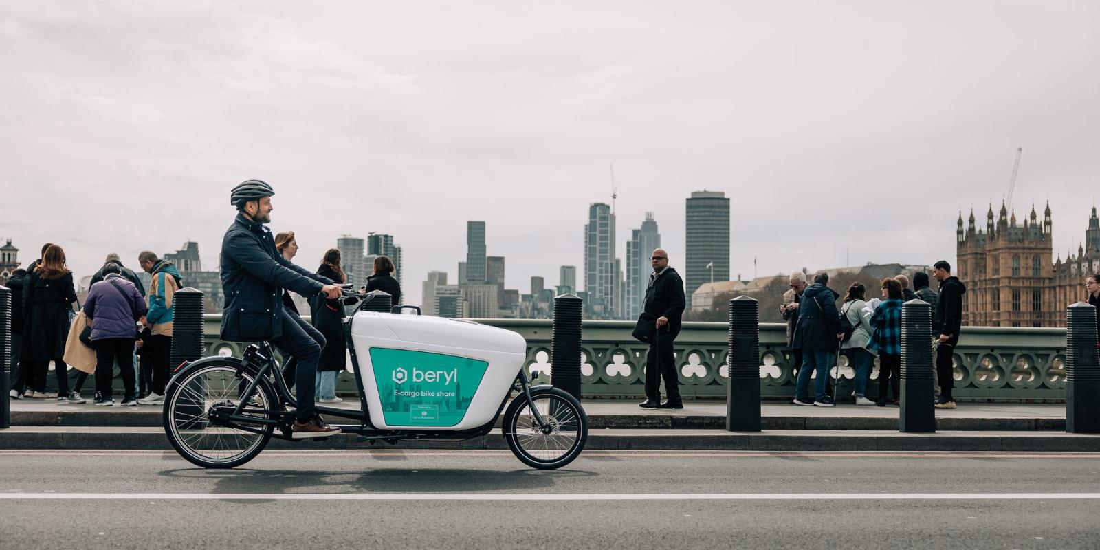 man riding Beryl e-cargo bike over Westminster bridge