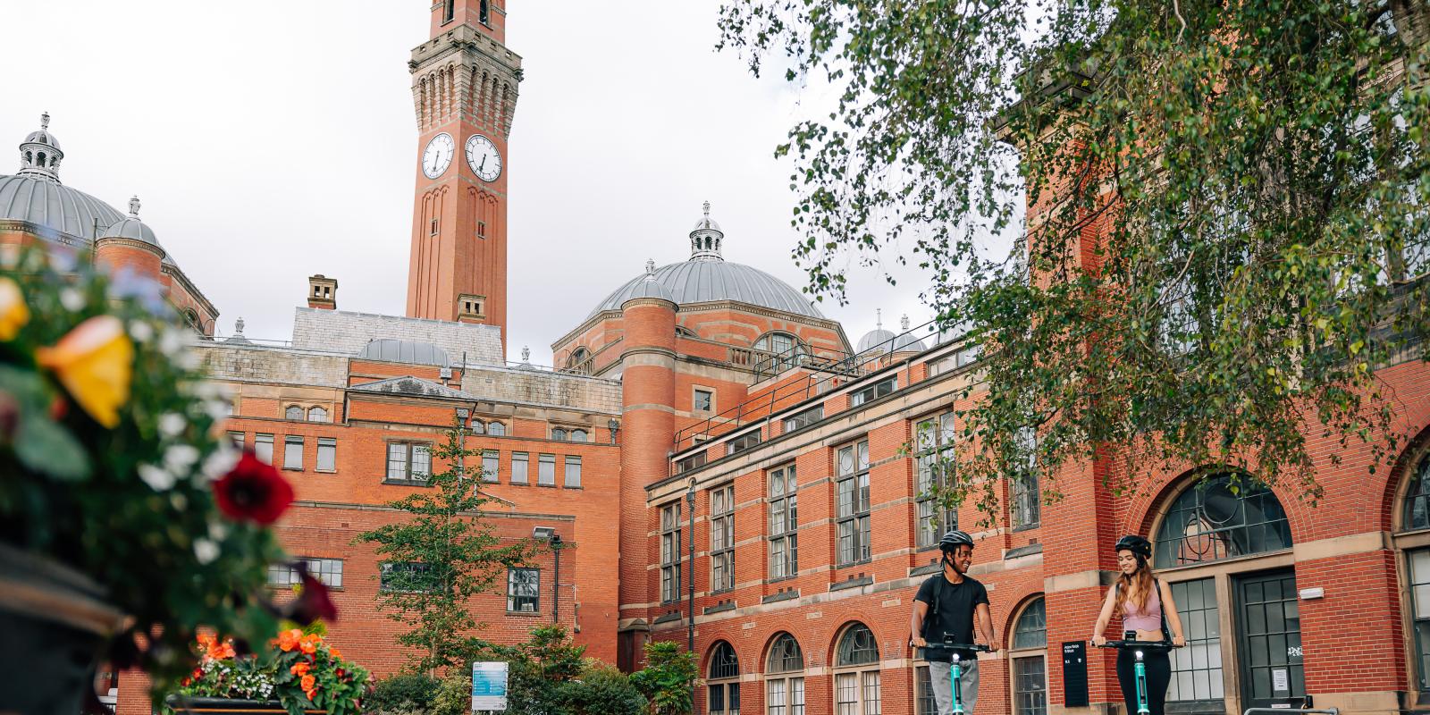 Man and woman riding Beryl e-scooters in Birmingham