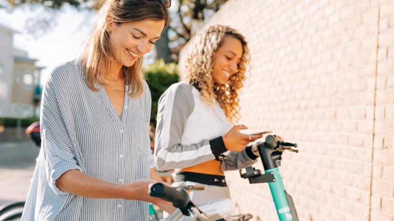 Two women using the app by their Beryl bikes