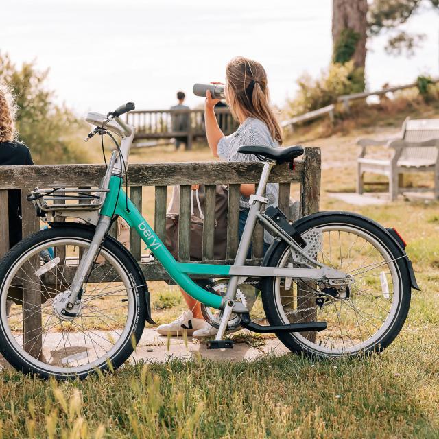 Women sitting on bench with Beryl bike in Dorset