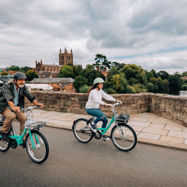 Man and woman riding Beryl bikes in Hereford