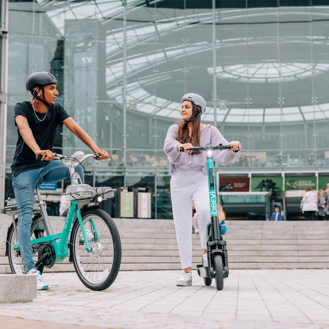 Man and woman riding Beryl e-bike and e-scooter in Norwich