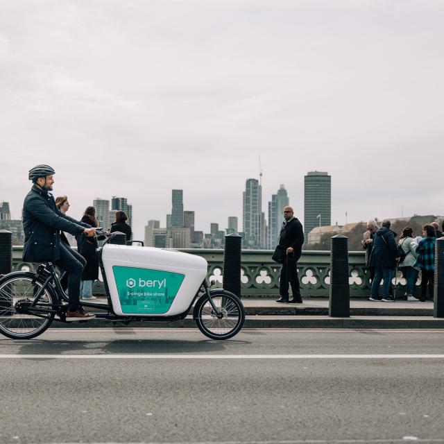 man riding Beryl e-cargo bike over Westminster bridge