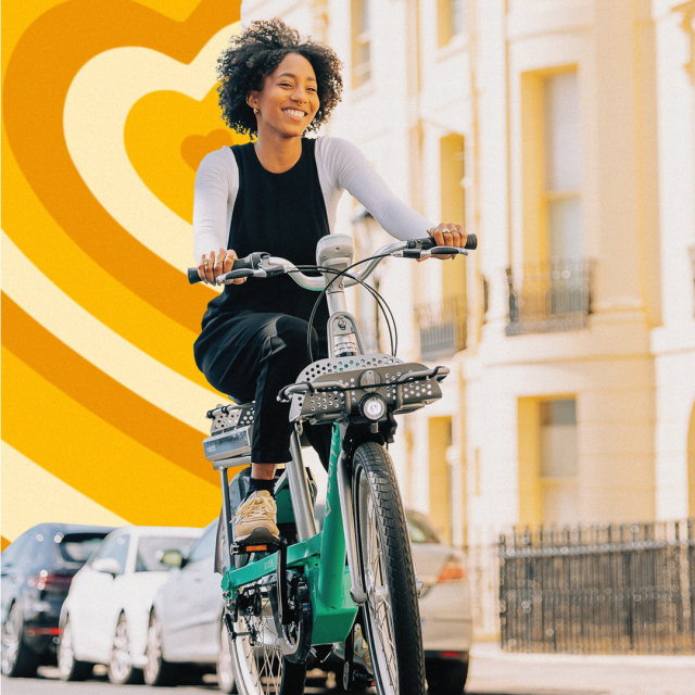 Woman riding bike down street