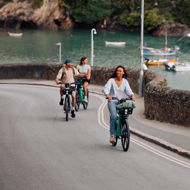 Cyclists in Newquay riding alongside the harbour 