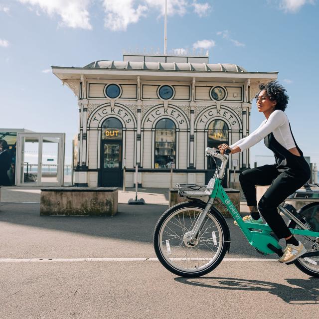 Woman cycling on Brighton promenade