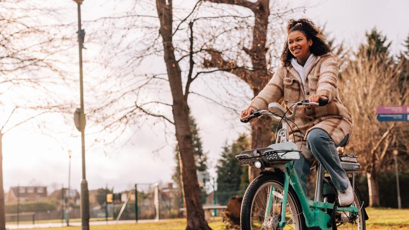 Woman riding Beryl bike in a park